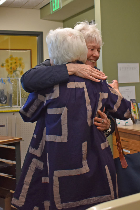 Greeting old friends: Charlotte McLain and Judy Palmer hugging. 