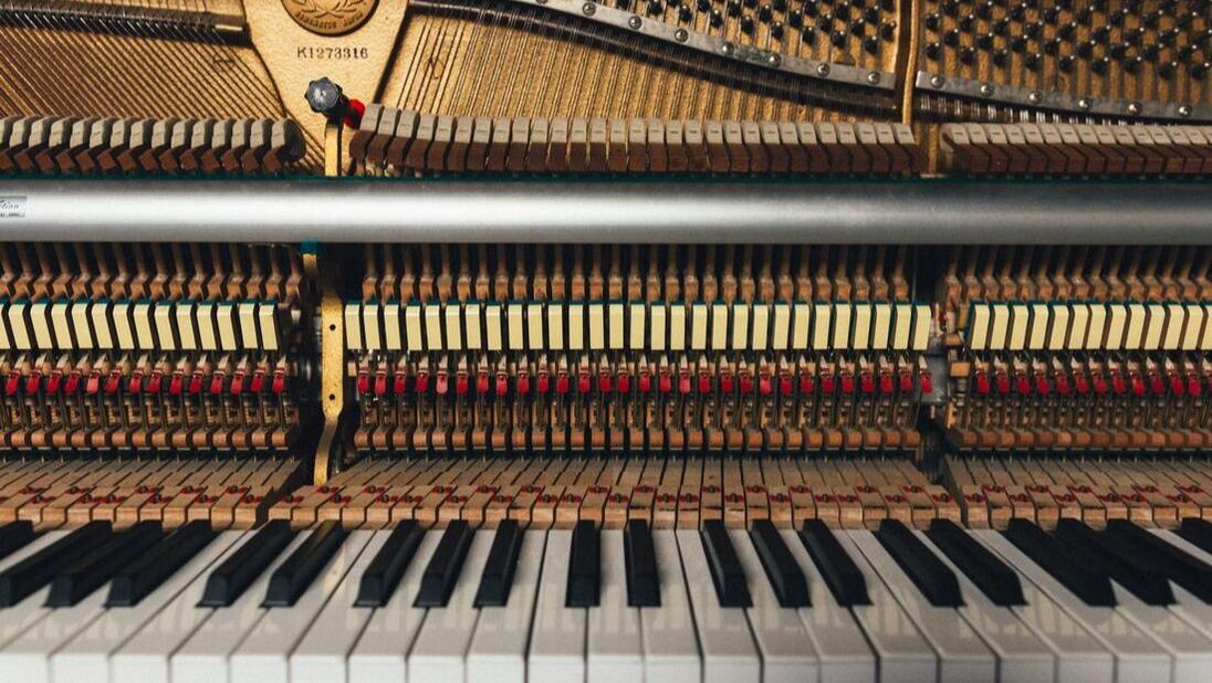 Photo showing piano keys and interior of piano